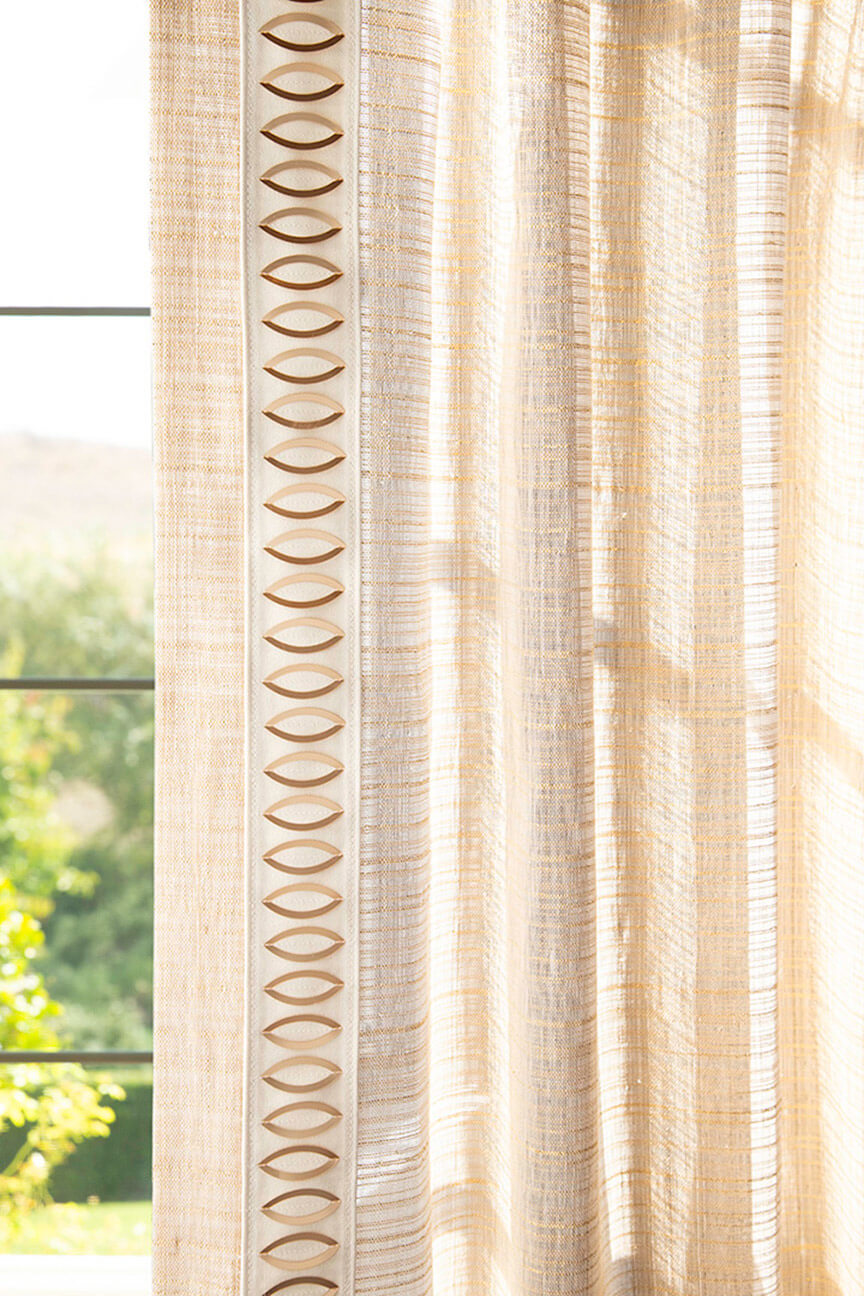 Custom window treatment trimmed the Orbit Border by Samuel and Sons.