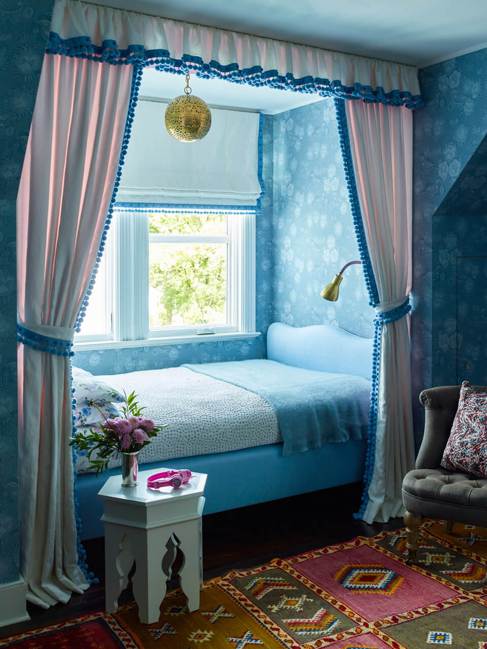 A dreamy tween hideaway designed by Robin Henry Studio is bathed in blue and trimmed with the Dolce Pom Pom Border and Fringe from Samuel & Sons. Photography by Eric Piasecki. 