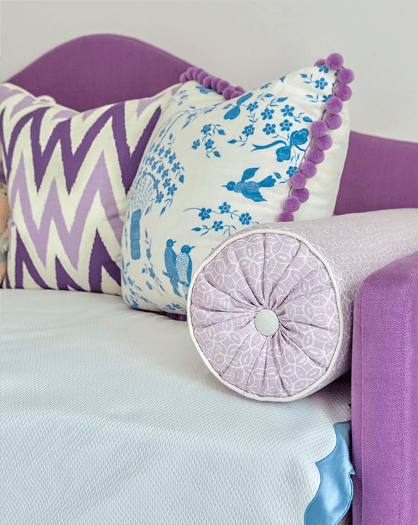 Kendall Rabun Interiors adds a splash of color to a girl's room with a playful mix of pattern and pom poms. Trimming pillows, Dolce Pom Pom Fringe from Samuel & Sons.