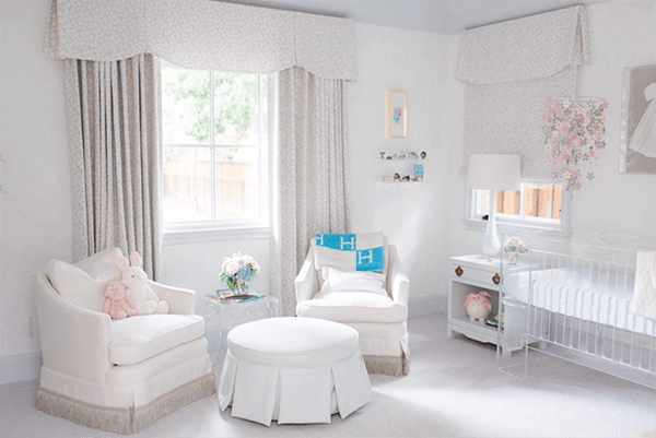 Softness surrounds in this nursery design by Molly Graham Design. A pair of cozy armchairs float atop fringed details: La Terre Cut Fringe from Samuel & Sons.
