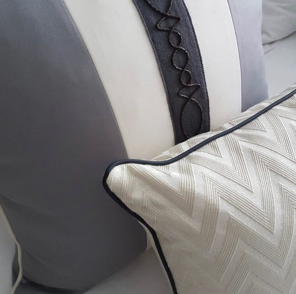 Custom pillow designs by Gunter & Co. using Samuel & Sons trim.