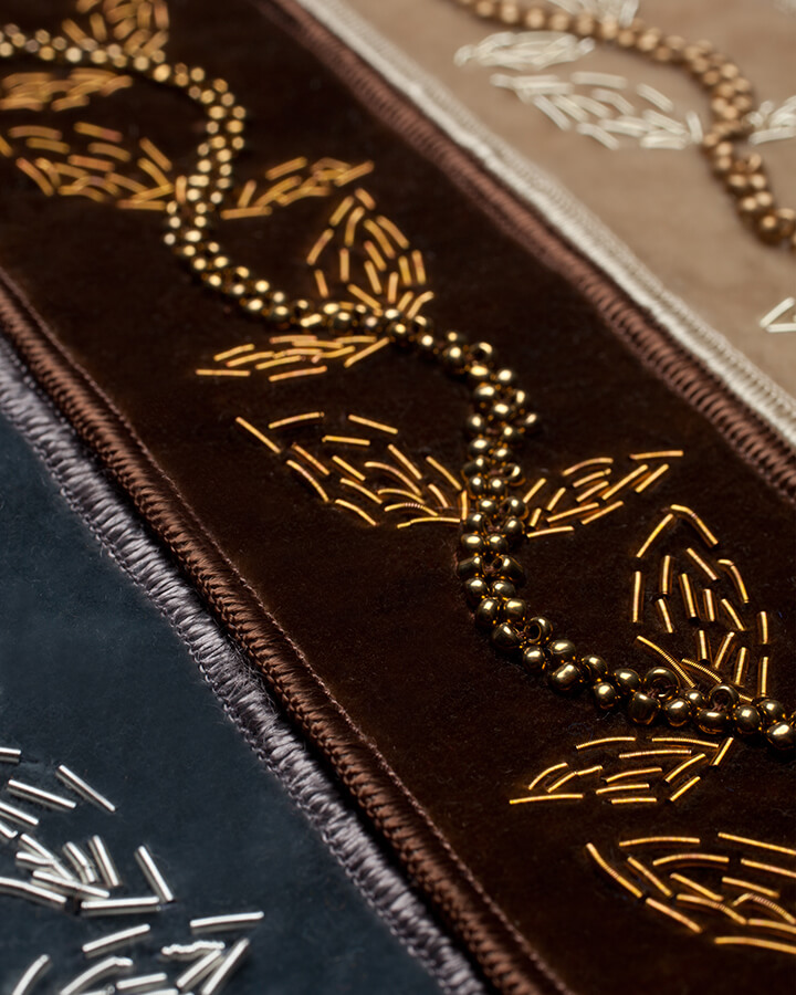 Three velvet borders with metallic beading embroidered in a vine motif.