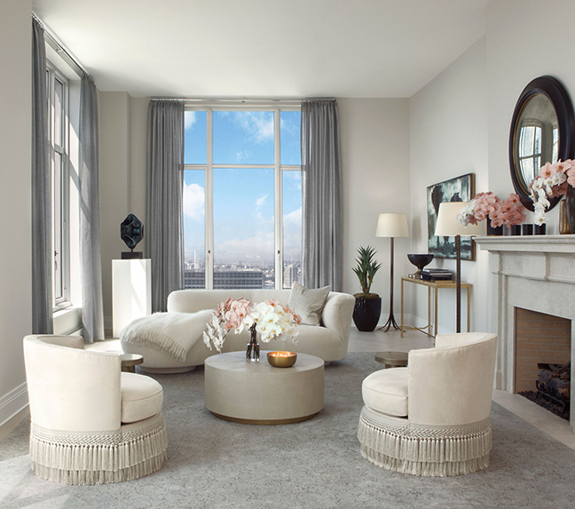 A neutral living room with round accent chairs