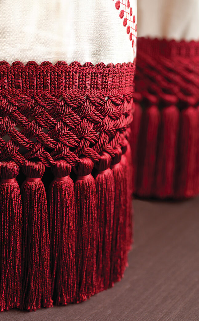 A close up shot of ruby colored Rouen Tassel Fringe 