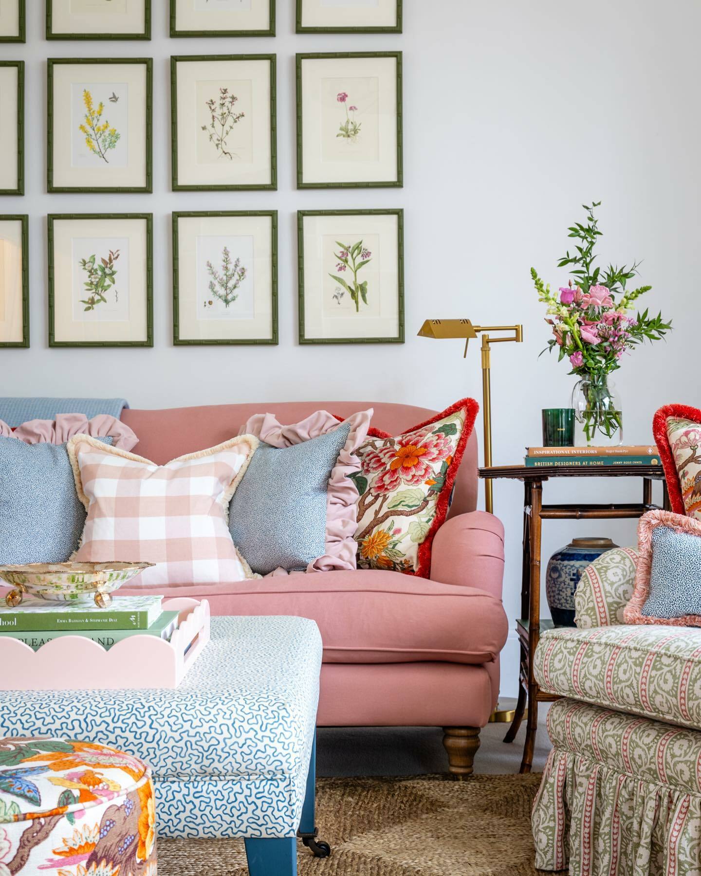 A traditional living room with pink and blue furniture and decorative throw pillows, creating a vibrant and colorful ambiance.